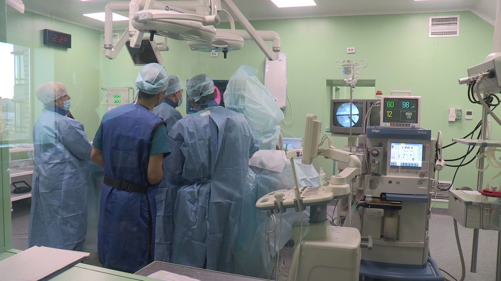 A theatre team gathered around the operating table