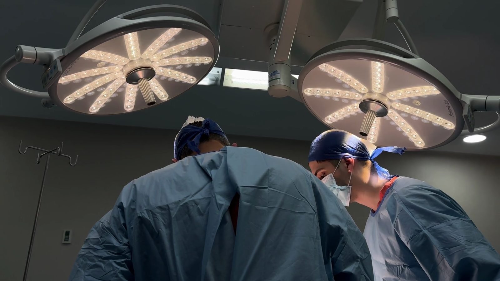 Surgeons at work under theatre lights